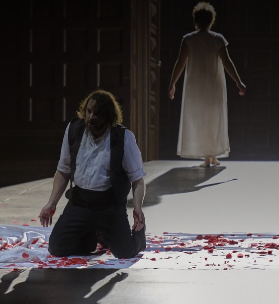 Rigoletto alone on knees as Gilda walks upstage in death