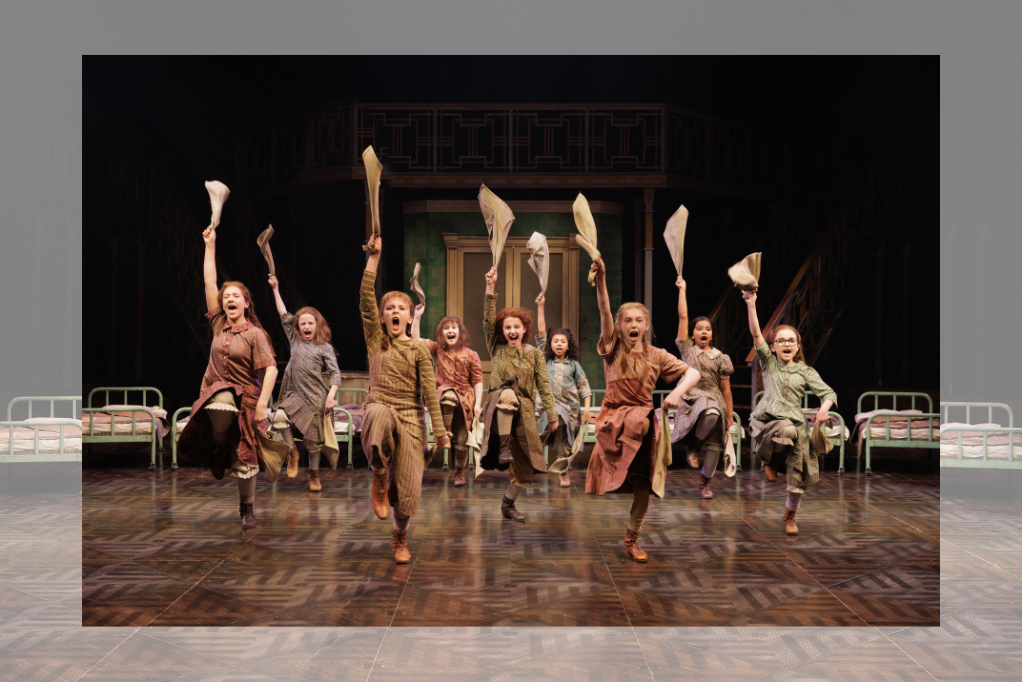 All the orphans dancing and waving cloths iin the air in rebellion, Annie in the middle.