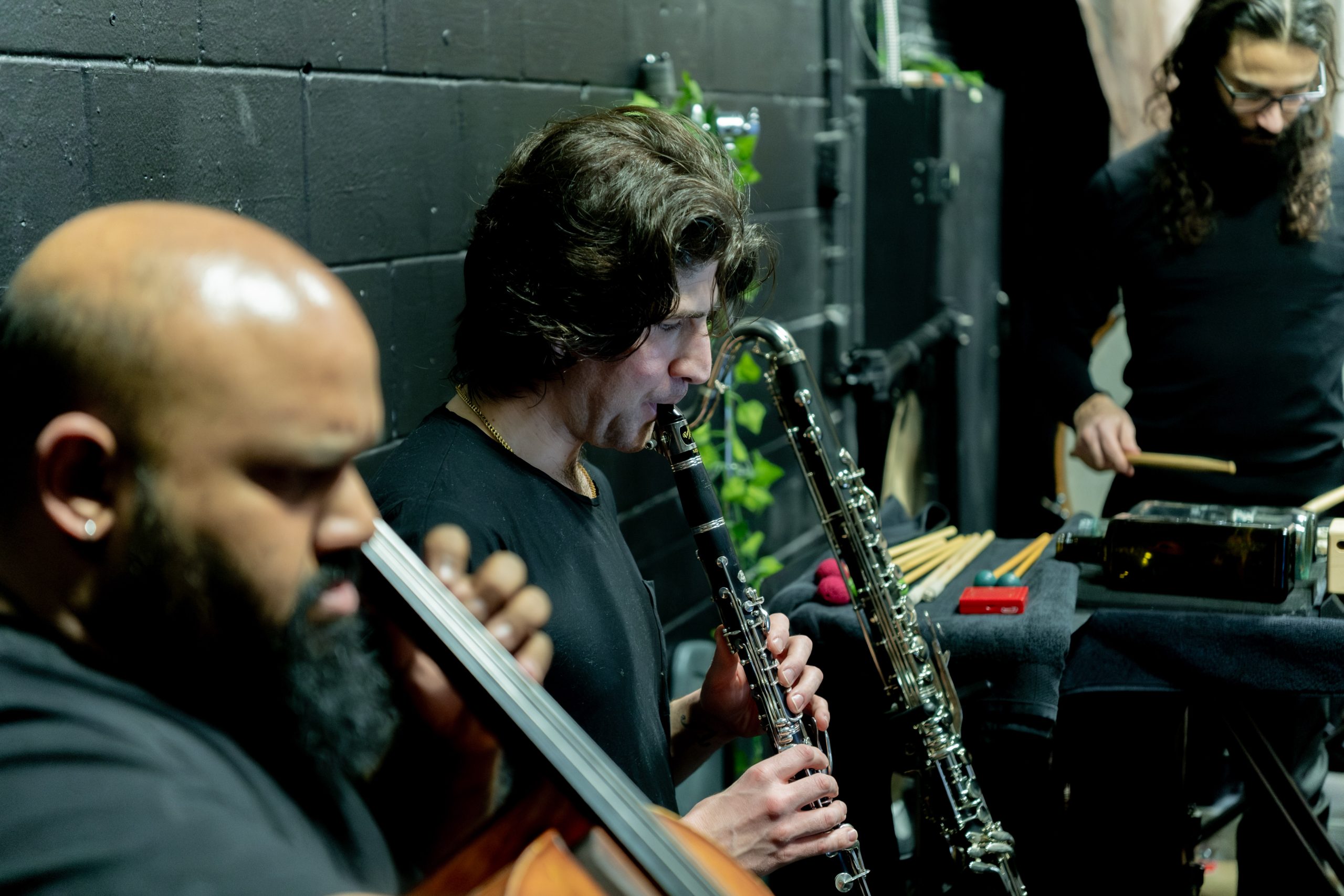 Musicians playing their instruments backstage.