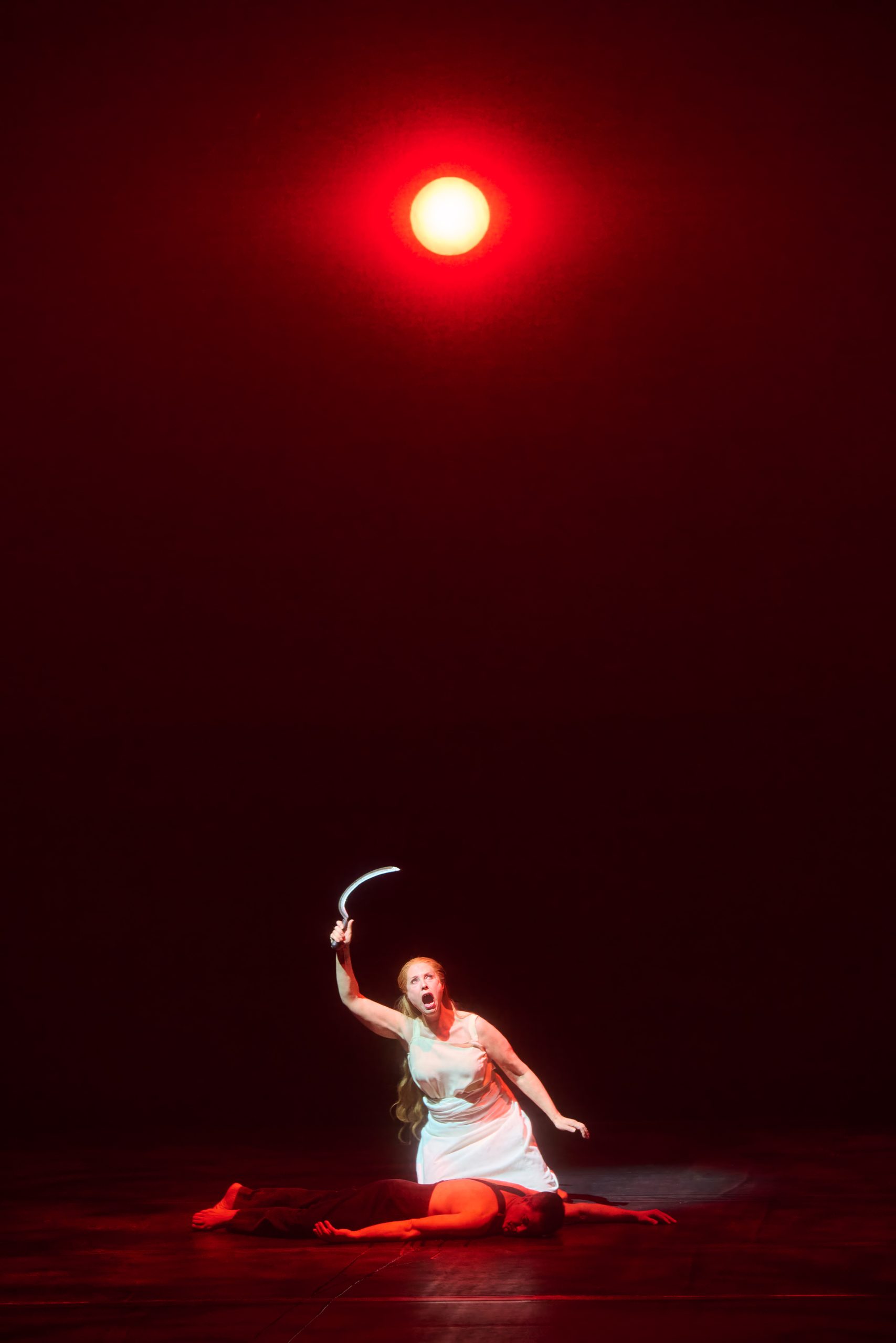 The Woman (with sickle) hovering over the dead body, blooy moon overhead.