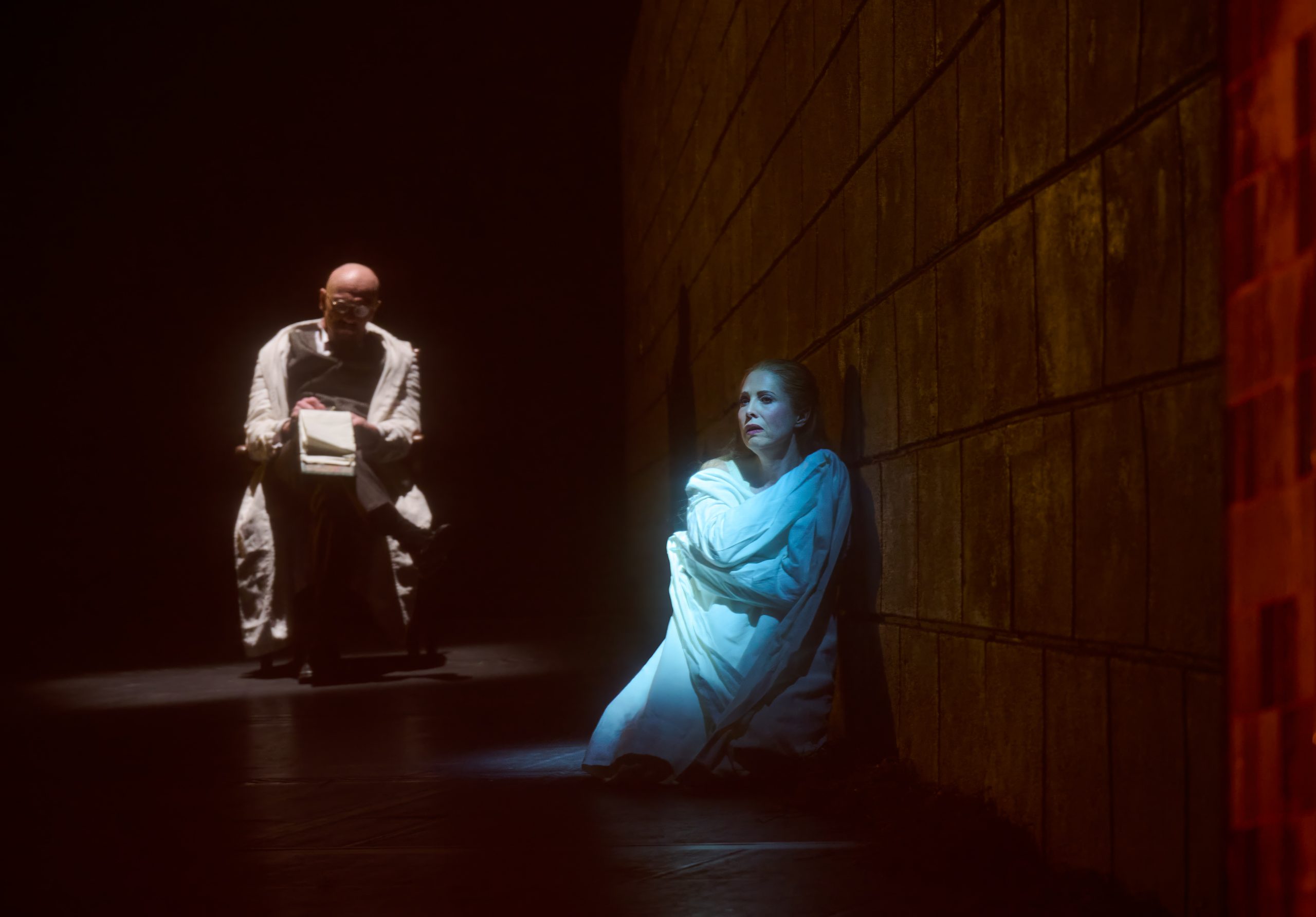The Woman hudled by the wall, the doctor taking notes behind her.