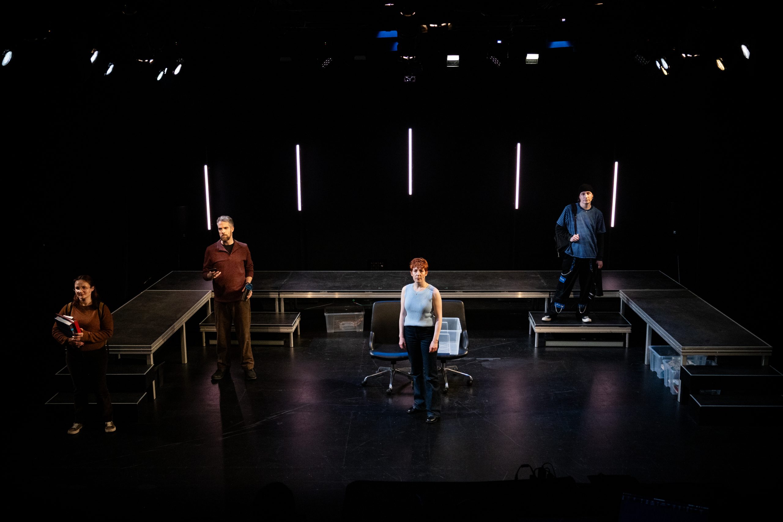 The Goodman family scattered over the set, Diana in the middle of the stage.