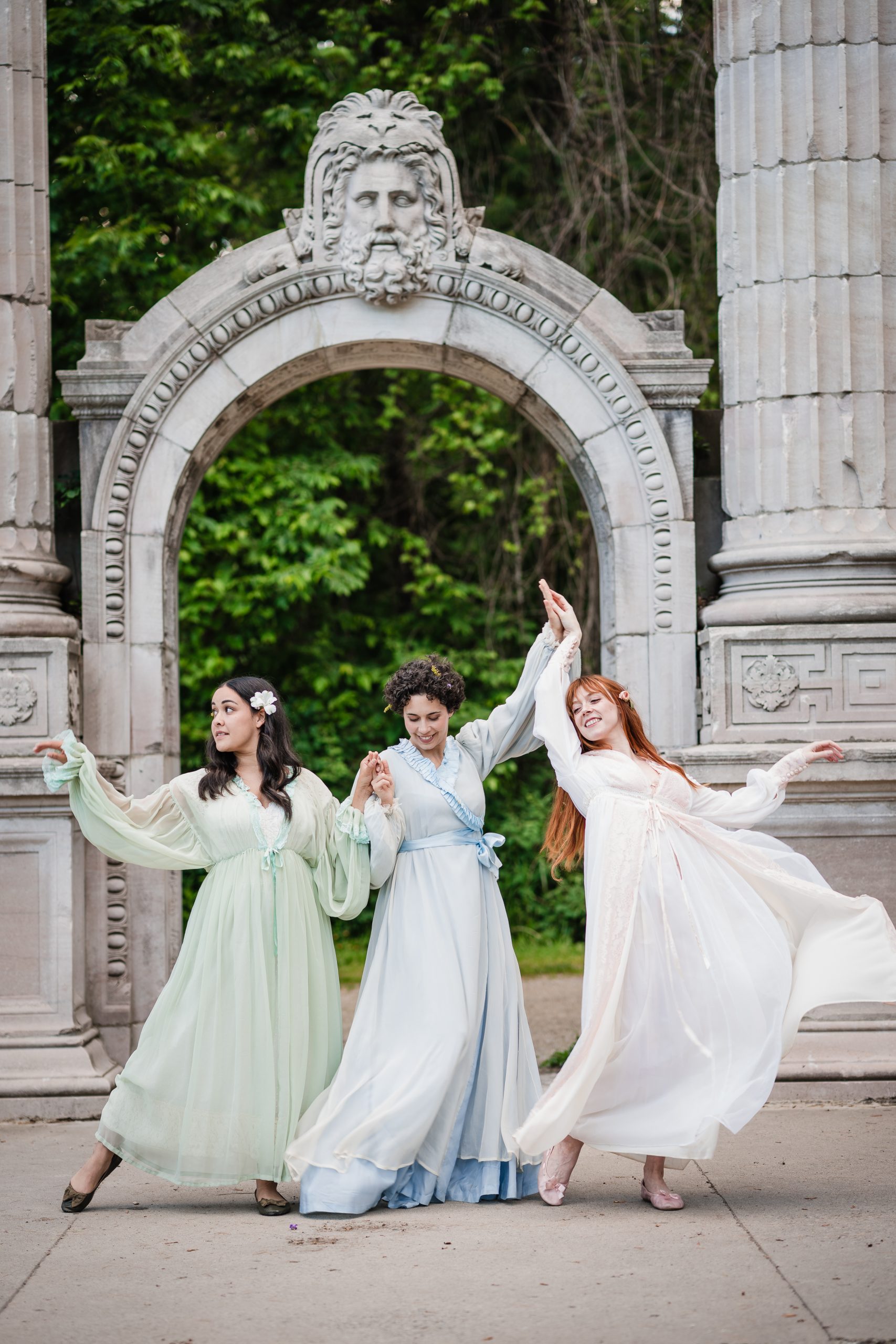 the three sisters are dancing in their white dresses