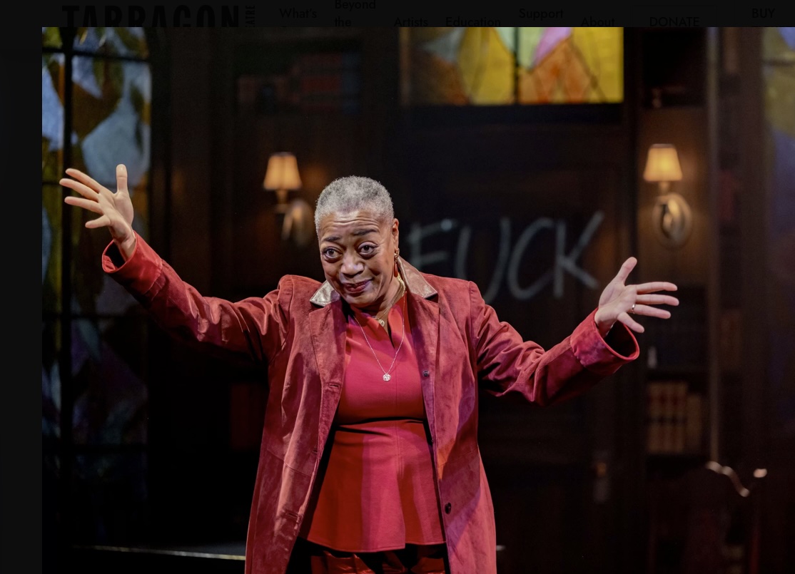 Karen Robinson as Prof. Margaret Anjou holding up her arms with great flourish and fanfare.